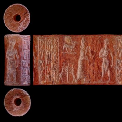 Cylinder seal. Kilted man with mace facing suppliant goddess, goat with crook on back set on ground line above two rearing antelopes with tree in between; ground line; inscribed. Old Babylonian. Carnelian, light translucent streaks.; YPM BC 004170