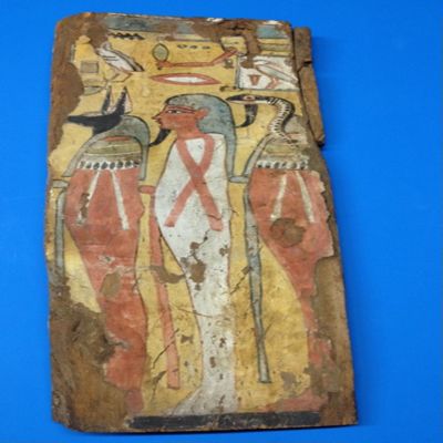 Wood coffin fragment. Painted with central anthropoid figure with jackal figure on left and asp figure on the right, heiroglyphics above. Left edge is painted, nailed wood pieces on right. 3rd intermediate period coffin approx. 1000 BC. 22' x 9' x 2' Egypt.; YPM ANT 269479