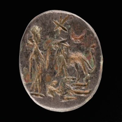 Amulet. Ob. Goddess(?) standing before lion trampling corpse; star and moon above. Rev: abrax/abra/pha/iao. Number of lines: 4. Metal.; YPM BC 038184