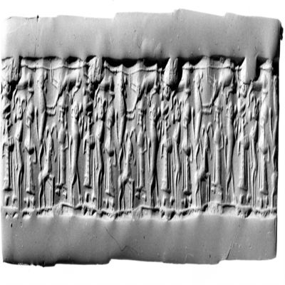 Cylinder seal. Rampant lion, two bearded human figures in long dress and round caps facing a rampent antelope, rampant lion on antelope?, facing bearded figure in long dress and rounded cap, above: two kneeling antelopes, single line border above and below. Mitannian. Frit, composite.; YPM BC 029875