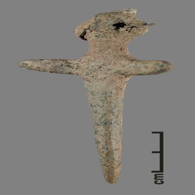 Figurine. Anthropomorphic figure with small conical hat, two earrings, arms spread, lower body ending like a peg. Bronze.; YPM BC 031127