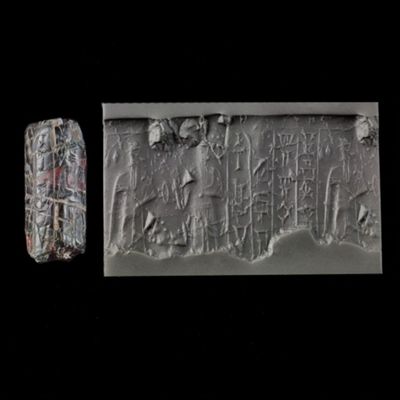 Cylinder seal. Ruler with mace/staff? facing male with one hand raised, rhomb, flower?. Kassite. Black/ brown agate with cream lines.; YPM BC 013937