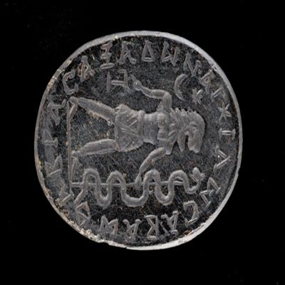 Amulet. Ob. Lion-headed god wearing kilt encircled by iao, sabaoth, abrasaz, adonai. Rev: Four stars, and eis theos. Black stone.; YPM BC 038187