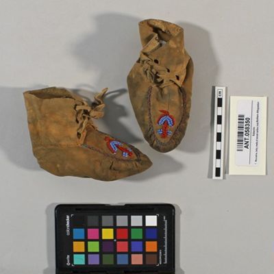 Moccasins, baby; made of tanned caribou hide decorated with blue and red beadwork; style of lacing has evidently been adopted from white shoes, made by Annie at Lower Post, BC, Bear Lake, N Athapaskan; YPM ANT 058350