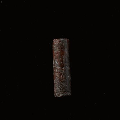 Cylinder seal. Five lozenges arranged vertically, dot rosette, seated figure; inscription. Kassite. Brownish jasper.; YPM BC 037167