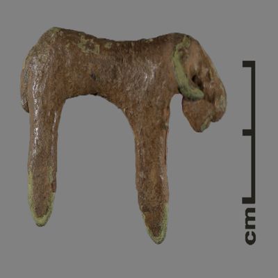 Figurine. Horned bronze bovine with front and hind legs joined to form pegs. Bronze.; YPM BC 031133