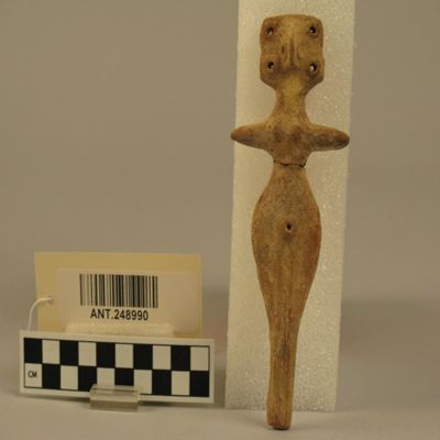 Ceramic figurine. Modeled breasts and navel; arms and legs merely painted without indication of hands and feet. Pronounced hips. Head rectangular with four perforations, one at each corner. Nose, while unperforated, has similar suggestions of a lateral hole. Hittite? Second millennium B.C.? Ht. 6' (15cm); Width at arms 2 1/2' (6cm). East Mediterranean.; YPM ANT 248990