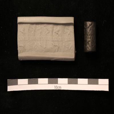 Cylinder seal. Frieze split by guilloche; above: two upright winged griffins confronting, two winged sphinxes below: lion attacking animal, two birds, rabbit, man on one knee. Syrian. Hematite.; YPM BC 037241