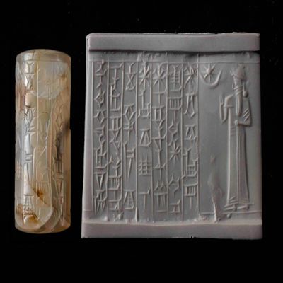 Cylinder seal. Standing bearded man; star in crescent above; inscription. Kassite. Milky/white agate.; YPM BC 006190