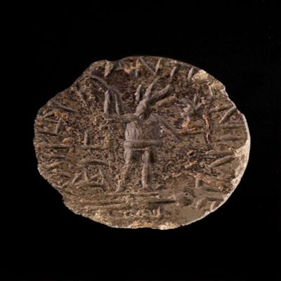 Amulet. Ob. Jackel-headed god with flail and plant (?) standing on a corpse; chnioybi? Anto-nino? (chipped). Rev: anguipede with four stars; Bevel: chipped Greek text. Stone.; YPM BC 038176