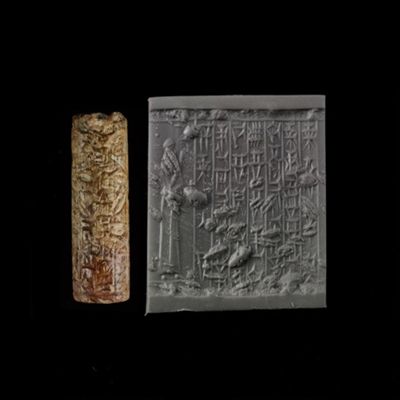 Cylinder seal. Male worshipper wearing cap, linear borders; 7-line inscription. Kassite. Mottled brown agate (?).; YPM BC 013941