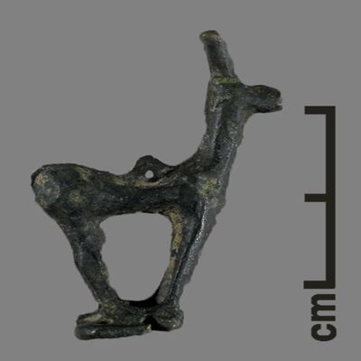 Figurine. Stag on base, suspension loop on back, base pierced with four holes. Bronze.; YPM BC 031107