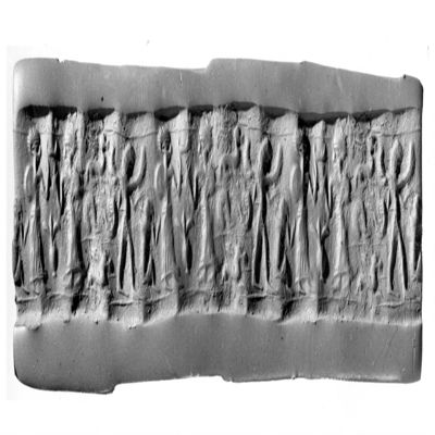 Cylinder seal. Two figures facing each other with rounded caps, long skirt and one hand raised, between them sprouting vessel and crescent, winged, lion-headed figure, monkey, chevron with animal below and above, single line border above and below. 2nd mill. Frit?.; YPM BC 029865
